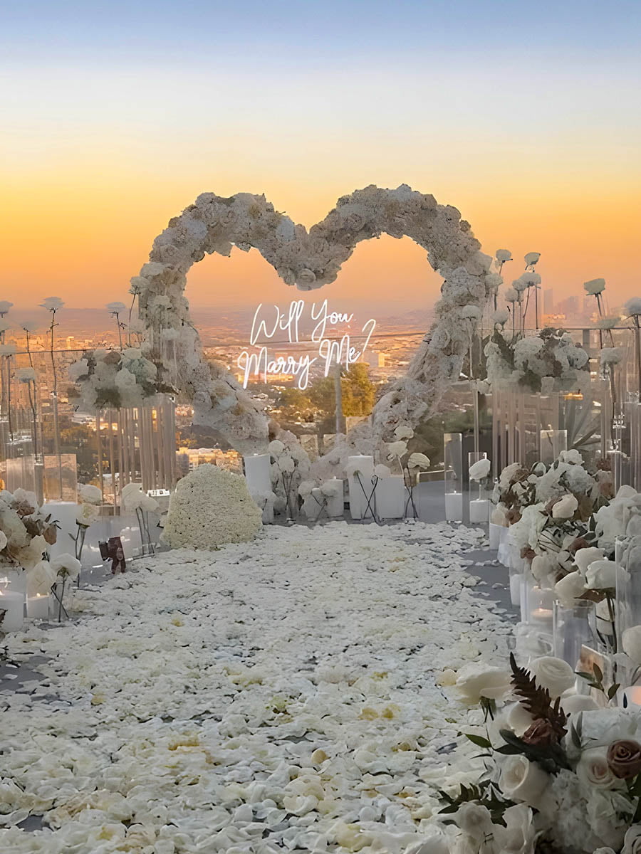 White Rooftop Proposal Heart Arch with City View
