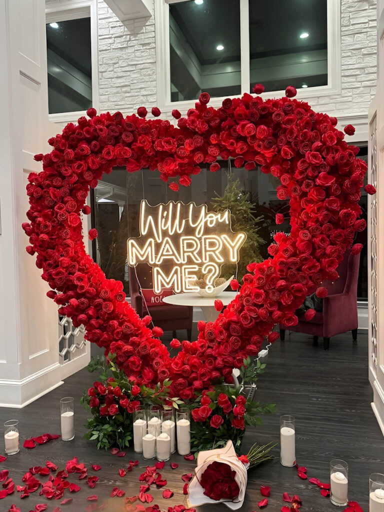 Elegant Indoor Proposal with Red Rose Heart Arch