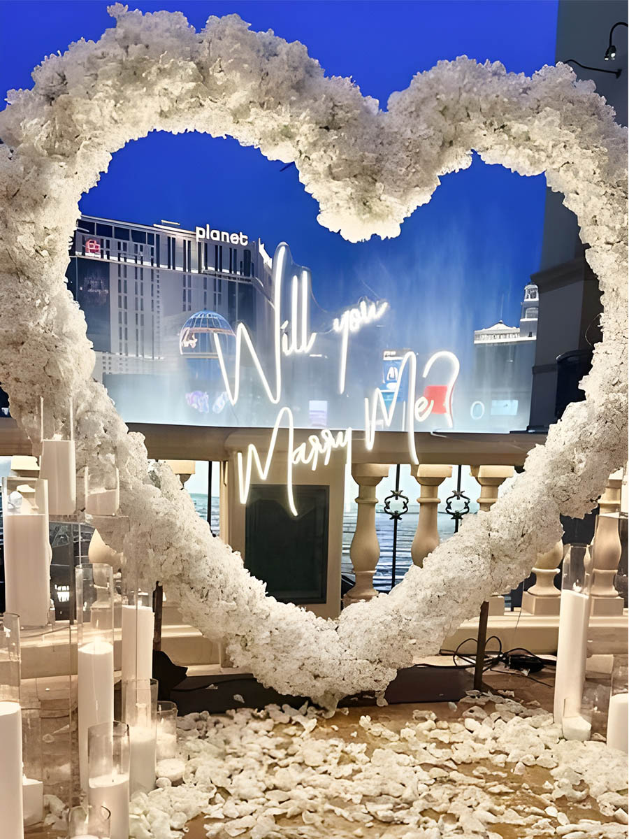 Vegas Night Proposal with Illuminated White Heart Arch
