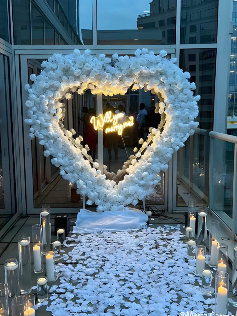 Balcony Proposal with White Flower Heart Arch