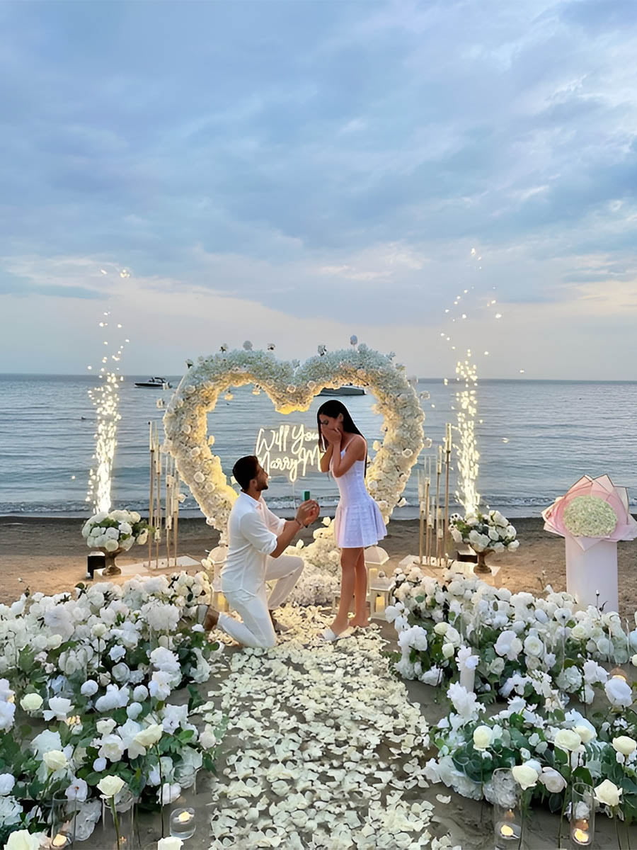 Beachside Proposal with White Heart Flower Wall