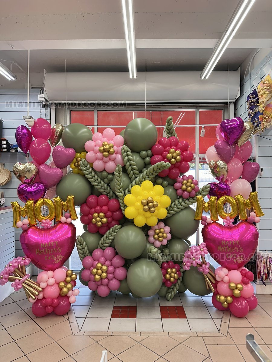 Pink, Green, And Gold Floral Balloon Display In An Indoor Venue