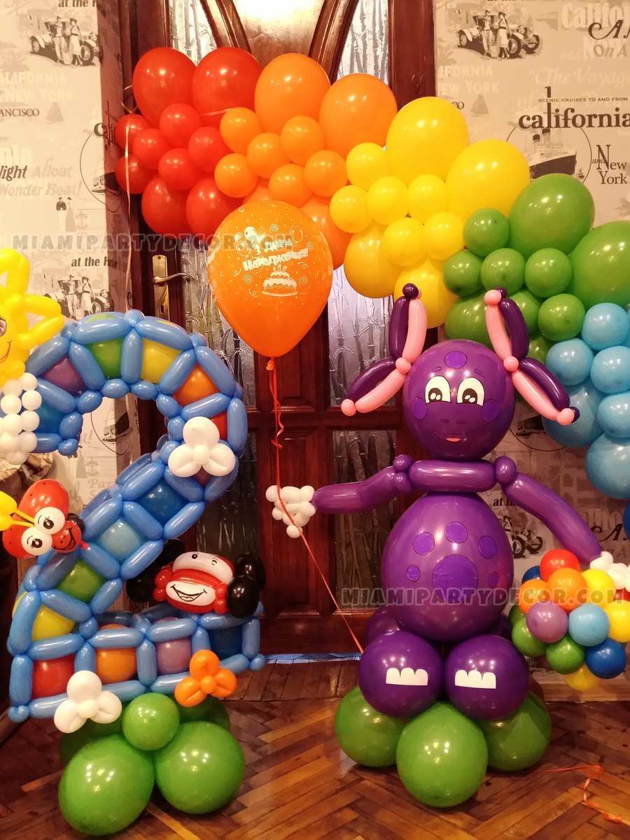 Colorful Balloon Arch With A Purple Character Sculpture