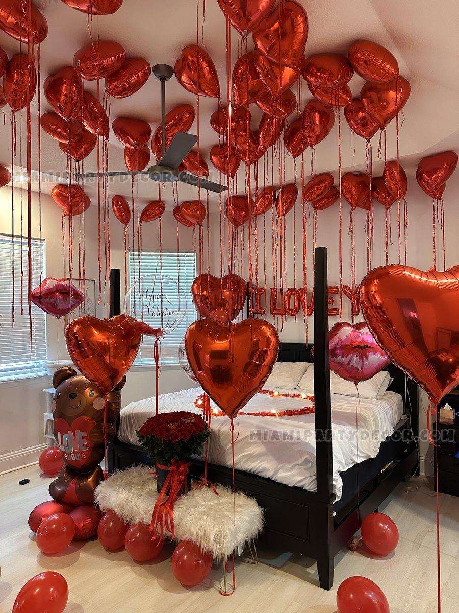 Red Heart Balloons Arranged Around A Decorated Bedroom