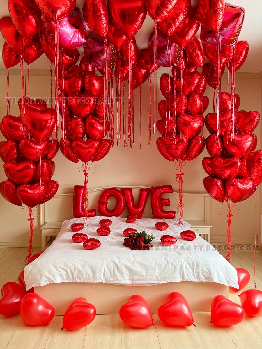 Red Heart Balloons Arranged Above A Bed With A Love Display