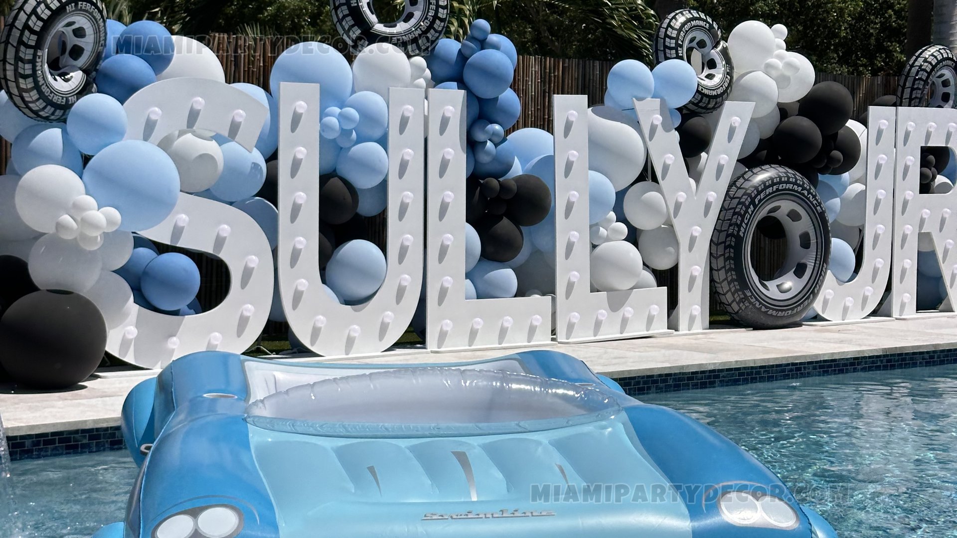 Blue And White Poolside Birthday Balloon Display With A Car-Shaped Float